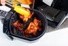 Taking cooked chicked out of an air fryer